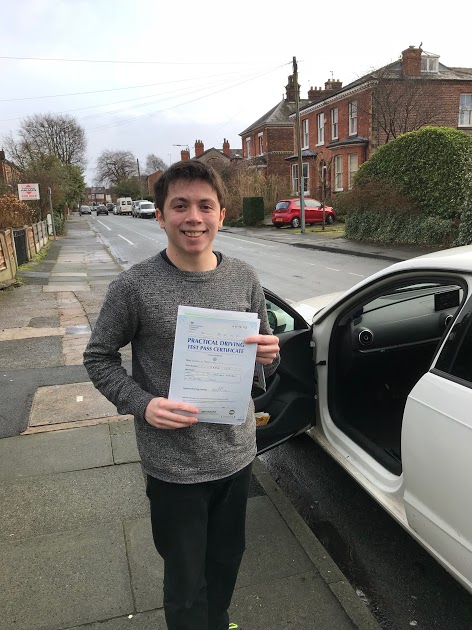 Student celebrating driving test pass with Drive Fleet instructor in Manchester